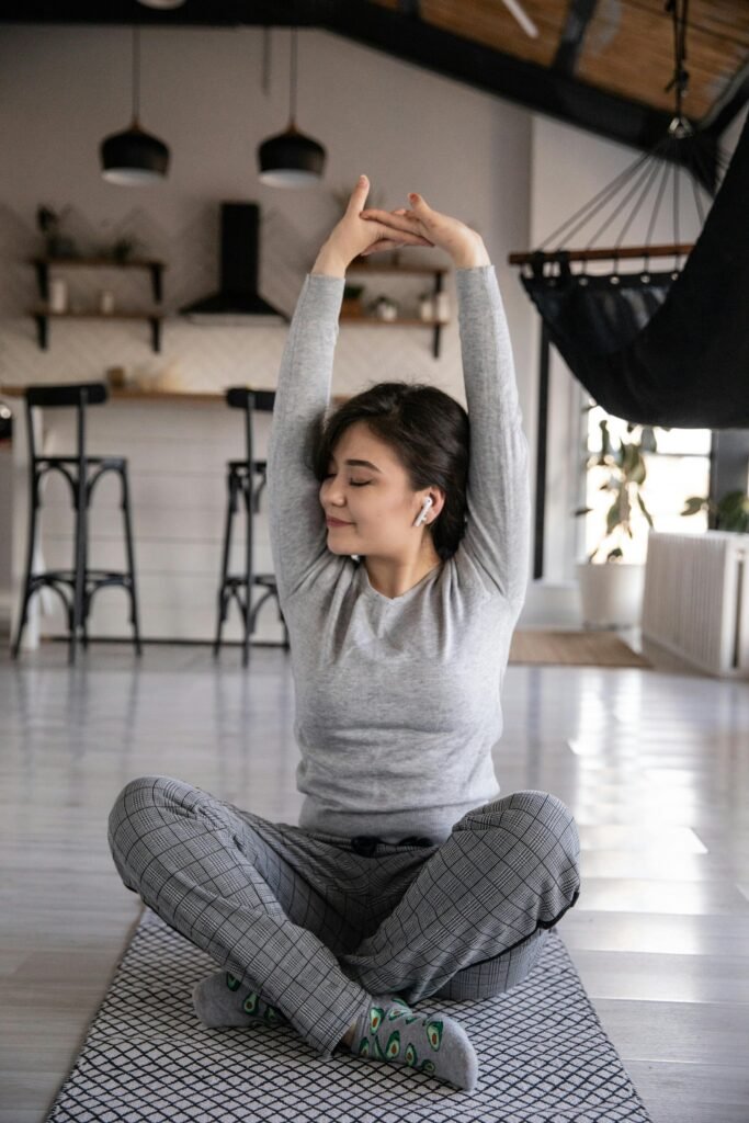 Woman practicing mindfulness and relaxation, showcasing how CalmTech-Life.com supports mental health and digital wellbeing through holistic practices.